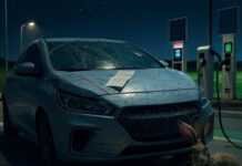 Zero-Emissions Road Trips: Charging Stations and Green Highways Scratched EV at charging station, jackrabbit nibbling cord.