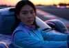 Women in Motorsports: The Rise of Female Drivers and Fans Blurry female driver with neon race car.