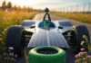Sustainability in Racing: How Green Efforts Shape the Future Blurry electric car zooms on wildflower track.